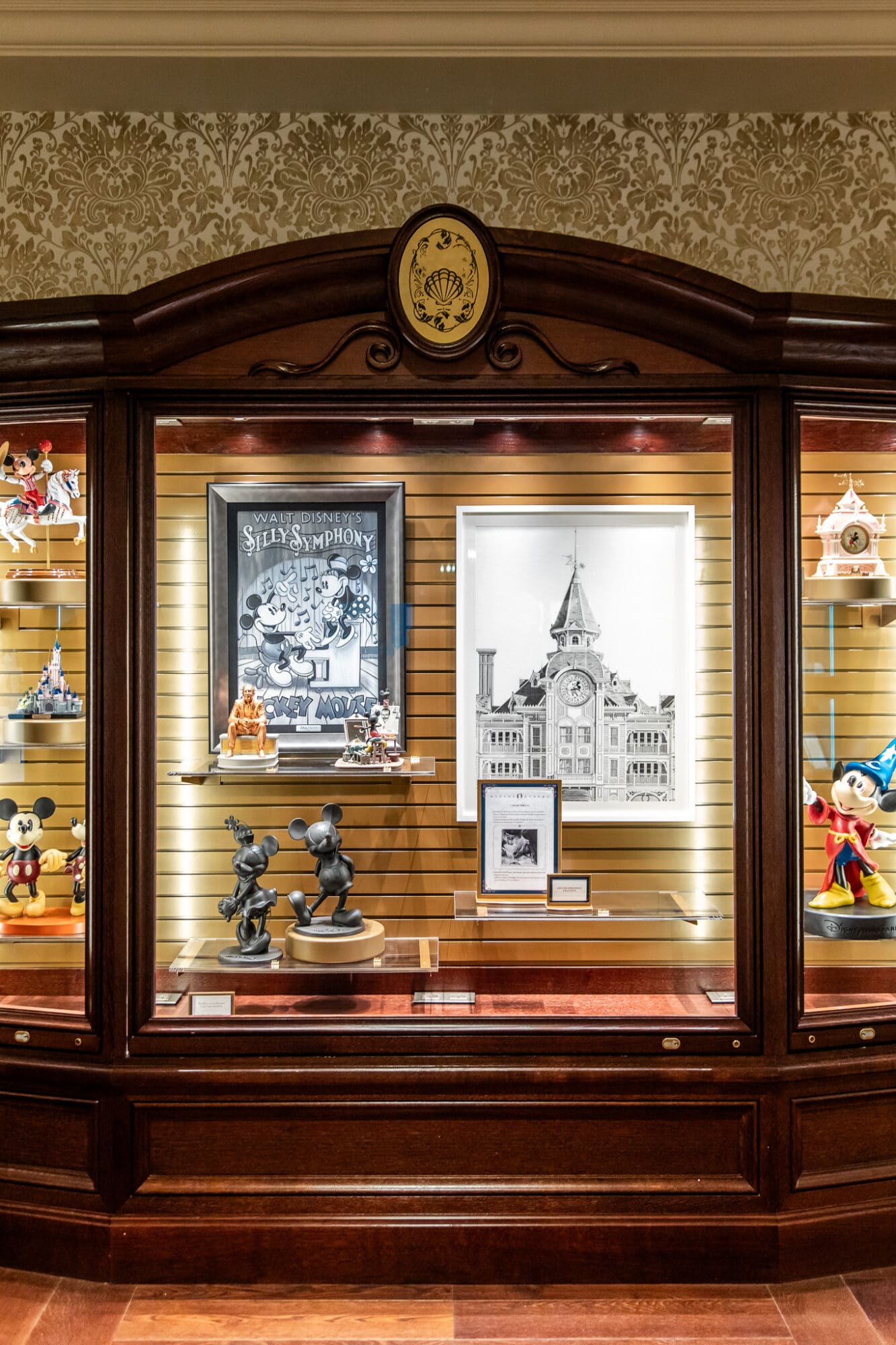 A photo of a display cabinet featuring vintage disney memorabilia and products available to purchase at Disneyland Hotel Paris