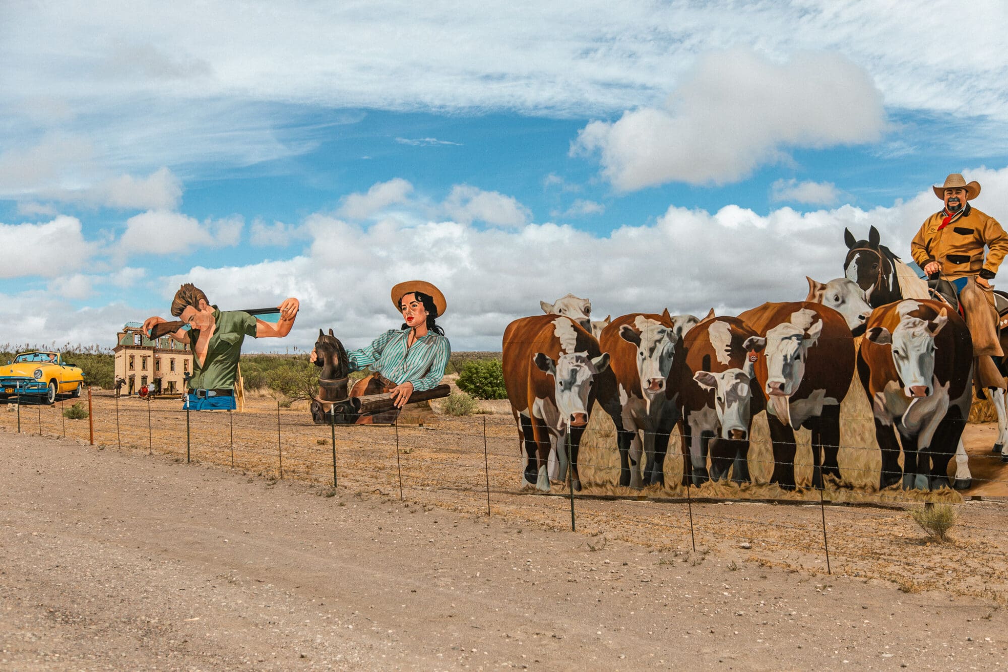 Oversized cutouts depict Hollywood Actors from the film "Giant" in an art installation by the side of the road in the Texas desert, near Marfa.