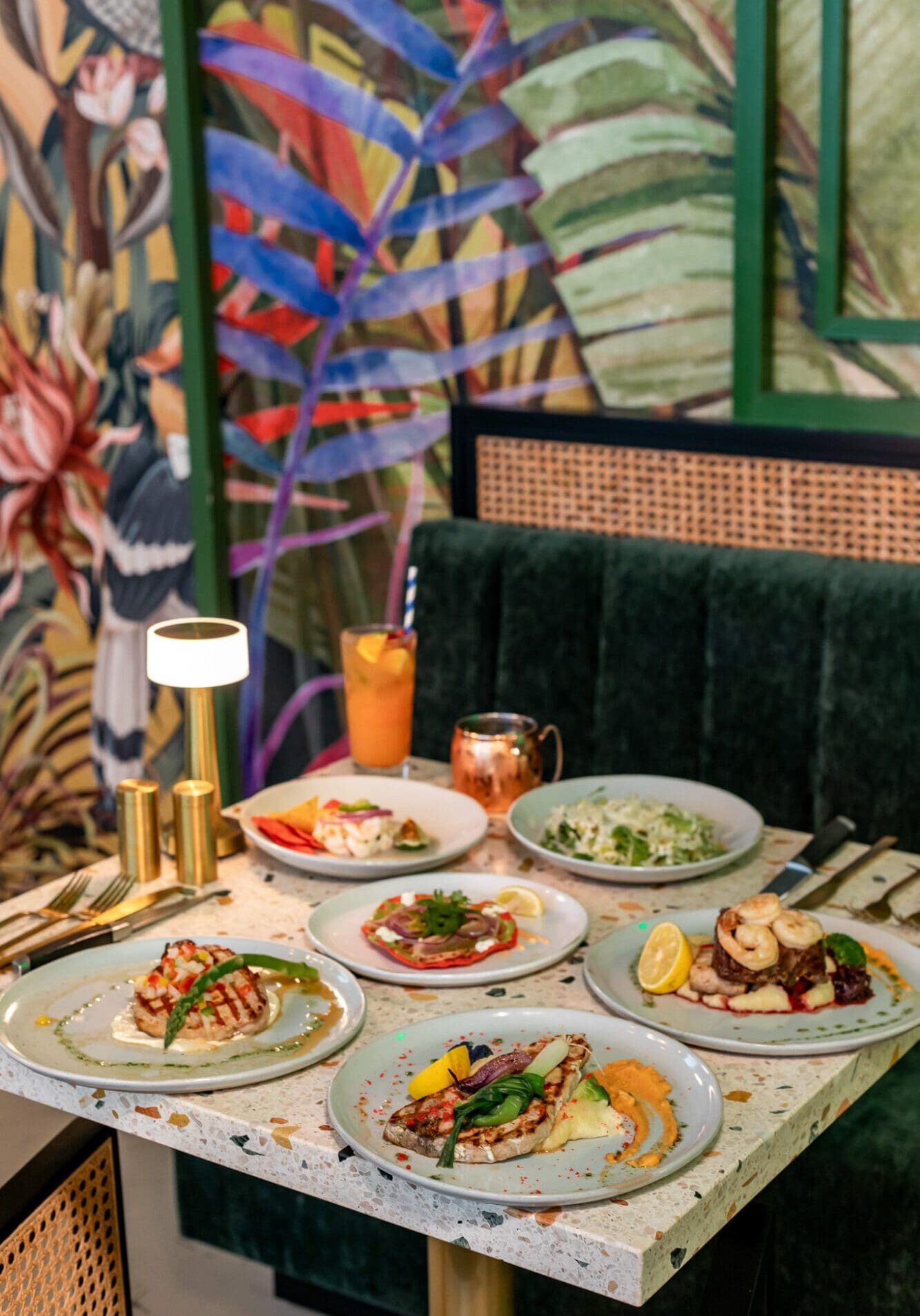 A selection of Latin American plates of food on a table at Zuka, a restaurant at Sandals Royal Curacao