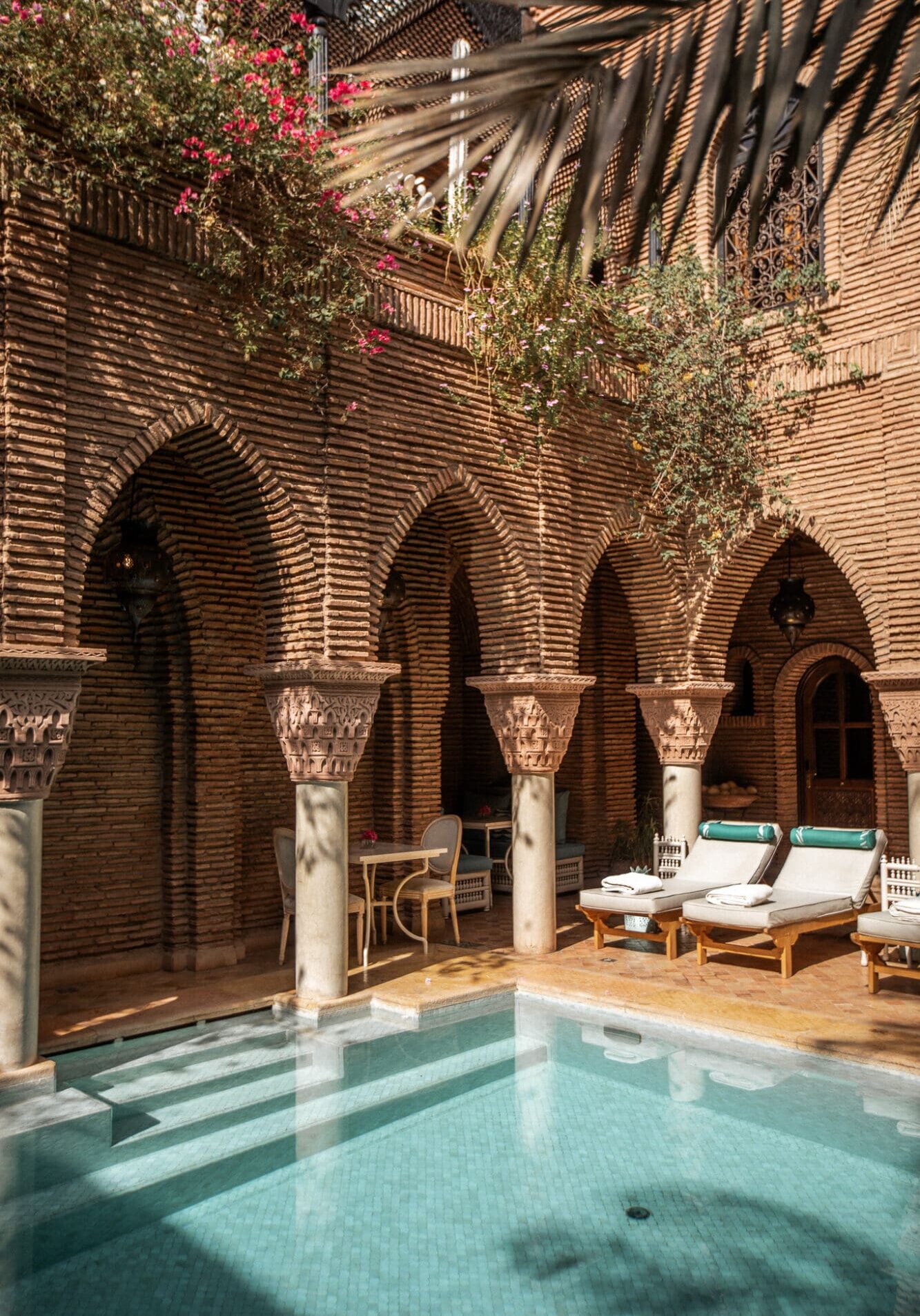 La Sultana Marrakech Review Pool Area through arches Luxury Hotels in Marrakesh