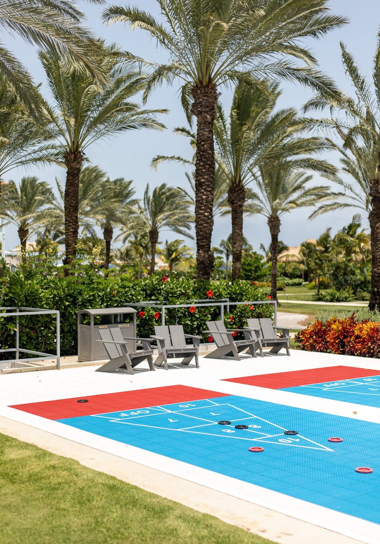 A photograph of a bright blue shuffleboard board at Sandals Royal Curacao