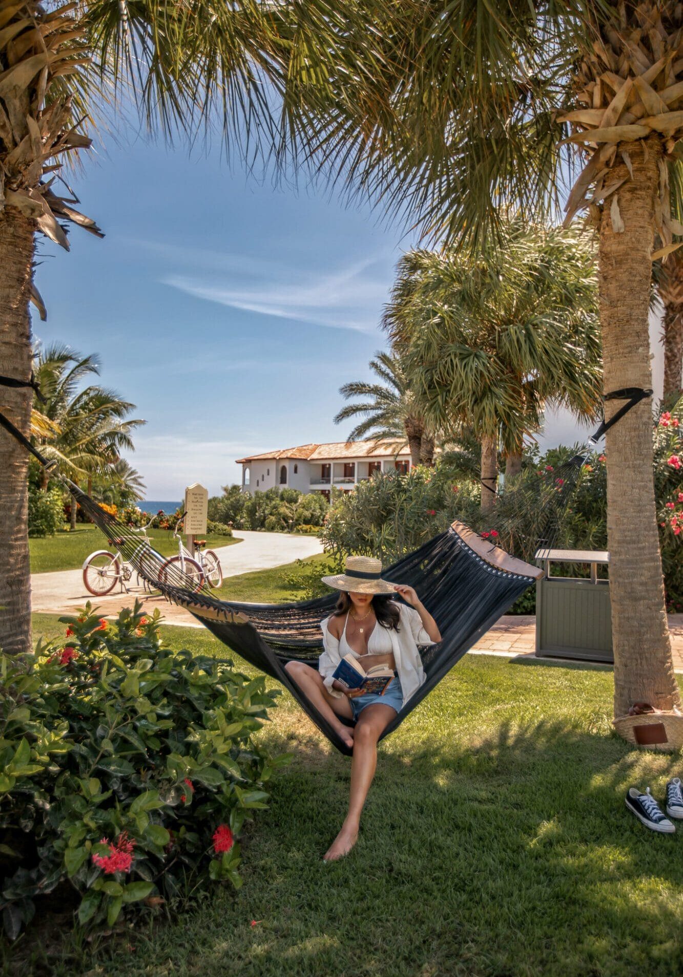 A girl reading a book on a hammock at Sandals Royal Curacao