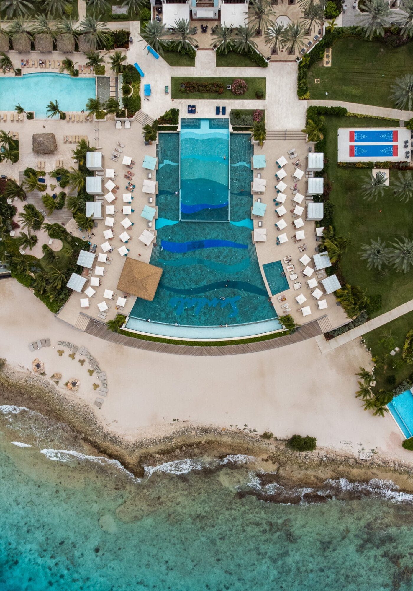 An aerial drone photography of the double infinity pool at Sandals Royal Curacao